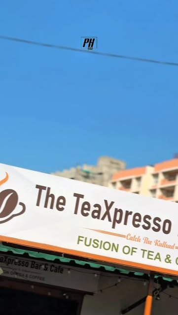The TeaXpresso storefront signage against a blue sky.